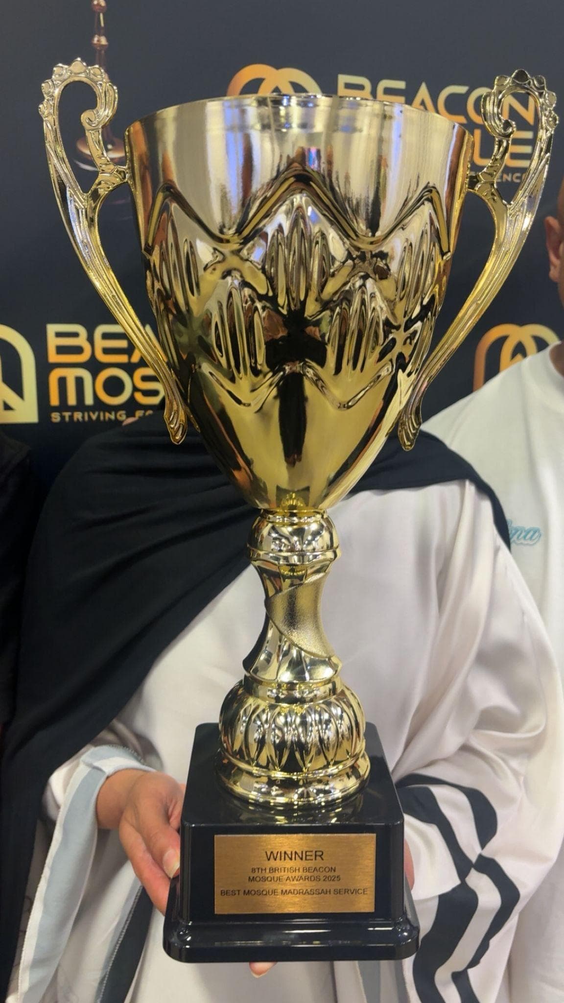 Aniqa Rashid with the British Beacon Mosque Award trophy